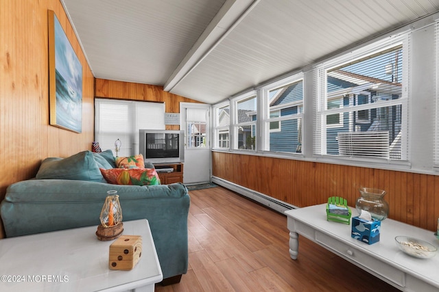 sunroom / solarium featuring a healthy amount of sunlight, lofted ceiling, and baseboard heating