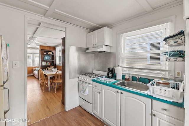 kitchen with ceiling fan, sink, coffered ceiling, white range with gas cooktop, and white cabinets