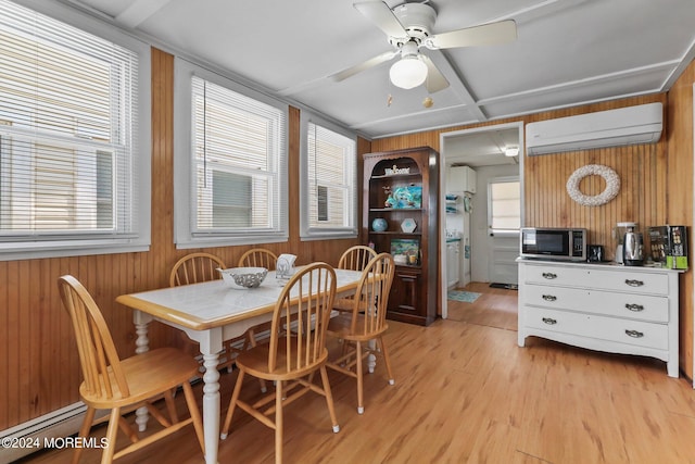 dining space with a baseboard radiator, light hardwood / wood-style flooring, a wall mounted AC, and ceiling fan