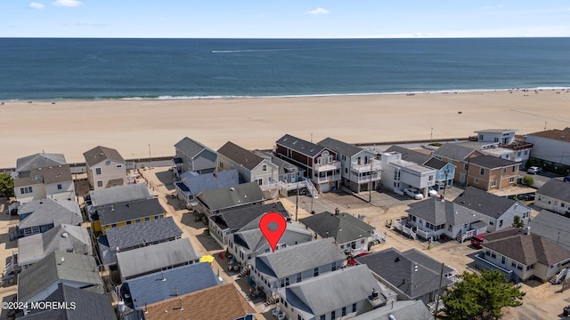 aerial view featuring a view of the beach and a water view