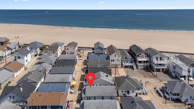 drone / aerial view with a beach view and a water view