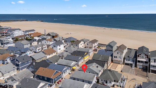 bird's eye view with a water view and a view of the beach