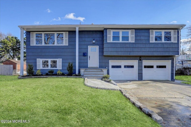 split foyer home with a front yard and a garage