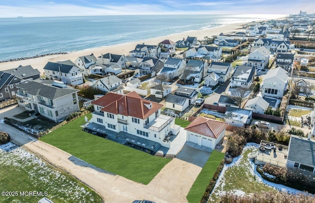 bird's eye view featuring a view of the beach and a water view