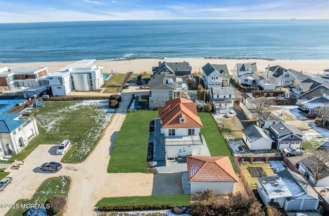 aerial view with a water view and a view of the beach