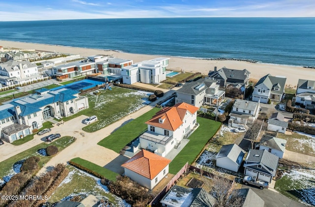 bird's eye view featuring a water view and a beach view