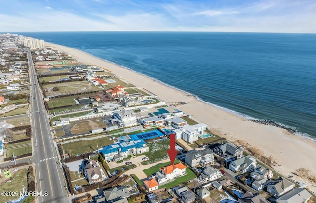 drone / aerial view with a beach view and a water view