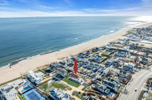 birds eye view of property featuring a view of the beach and a water view