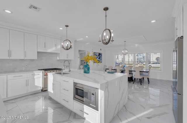 kitchen with a kitchen island with sink, sink, white cabinetry, and stainless steel appliances