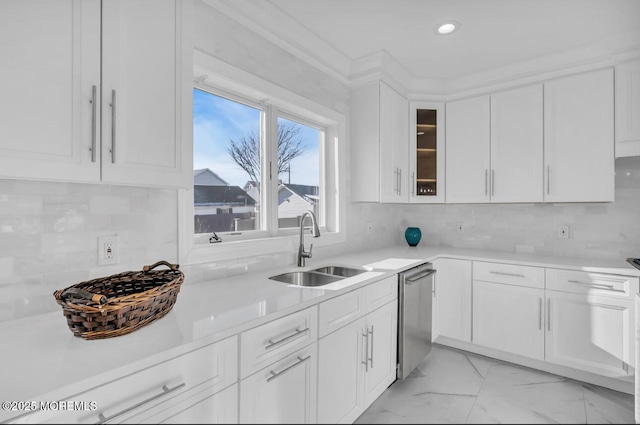 kitchen featuring sink, decorative backsplash, and white cabinets