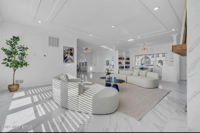 living room with a notable chandelier, built in shelves, and ornamental molding