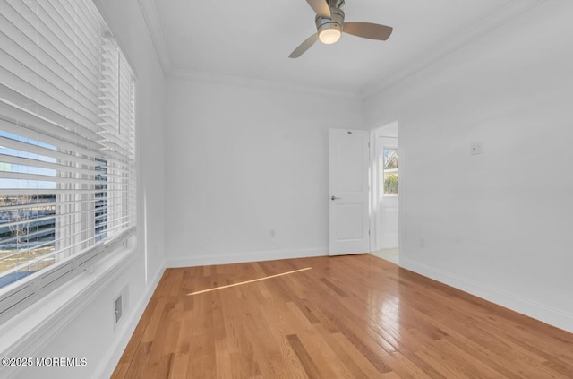 spare room featuring ornamental molding, ceiling fan, and light hardwood / wood-style flooring