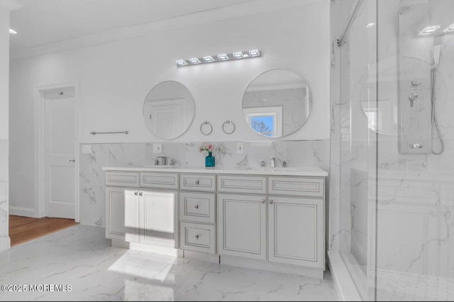 bathroom featuring vanity, crown molding, a shower with shower door, and tile walls