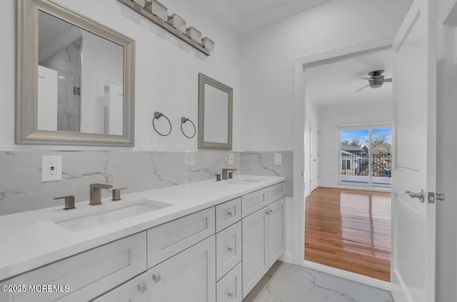 bathroom featuring vanity, ceiling fan, and decorative backsplash