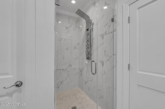 bathroom with a shower with door