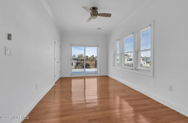 spare room featuring crown molding, hardwood / wood-style flooring, and ceiling fan