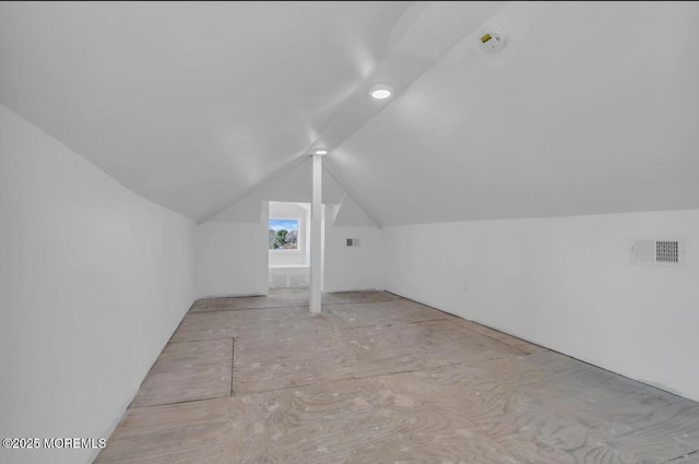 additional living space featuring vaulted ceiling