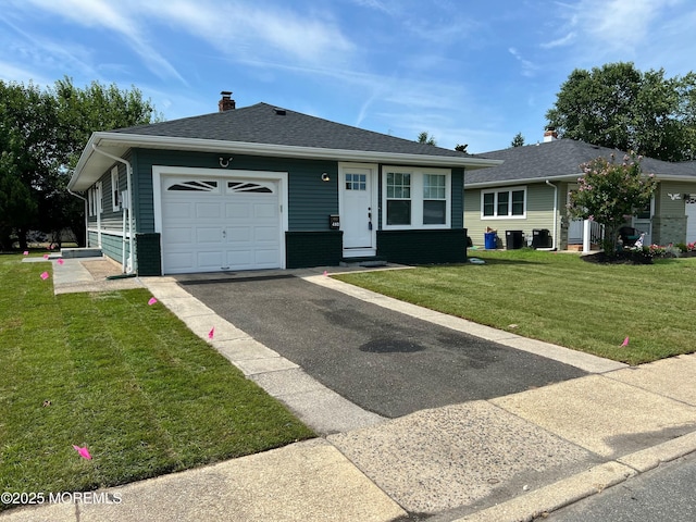 ranch-style home with a front yard and a garage