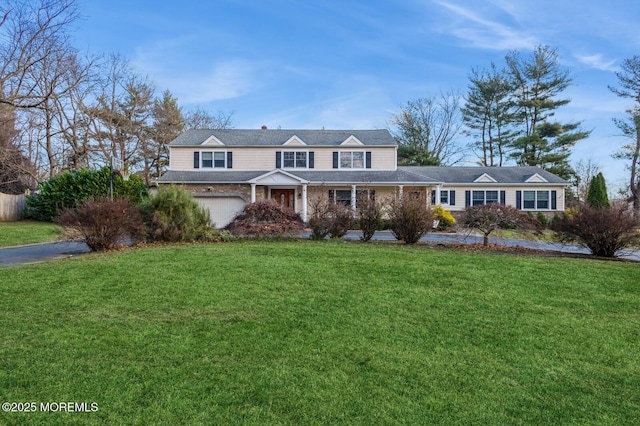 view of front of home featuring a garage and a front lawn