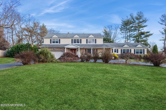 view of front facade with a front yard and a garage