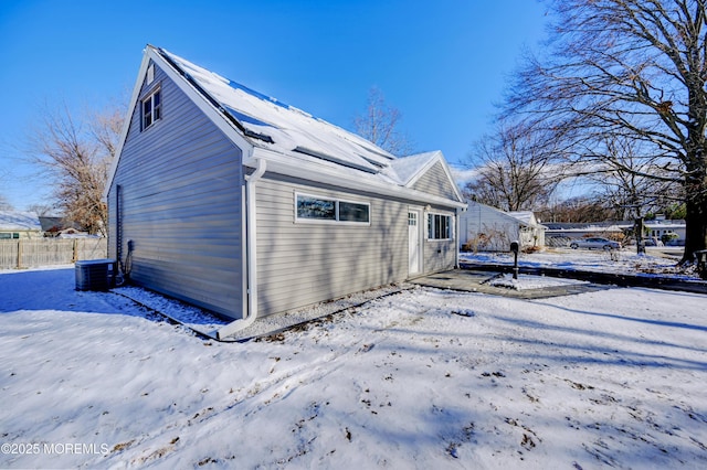 view of snow covered exterior featuring central air condition unit