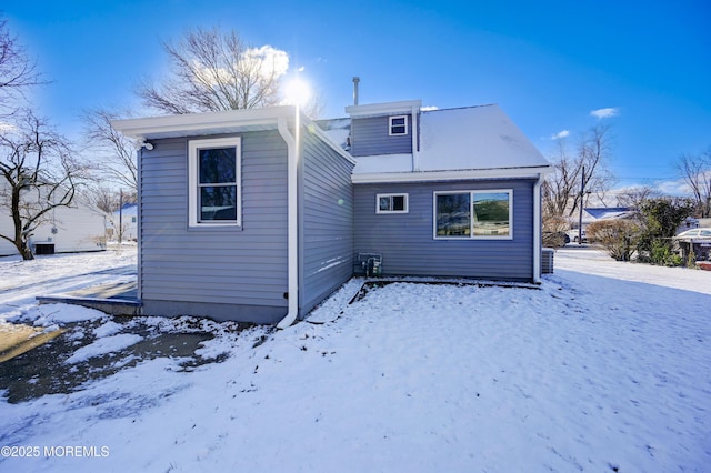 view of snow covered rear of property