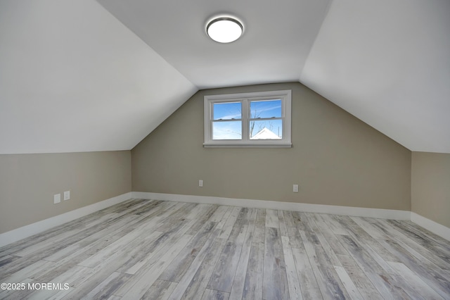 bonus room with light hardwood / wood-style floors and lofted ceiling