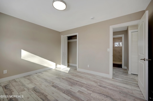 unfurnished bedroom featuring light hardwood / wood-style floors and a closet