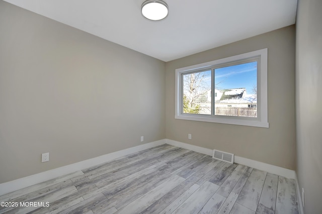 spare room with light hardwood / wood-style floors