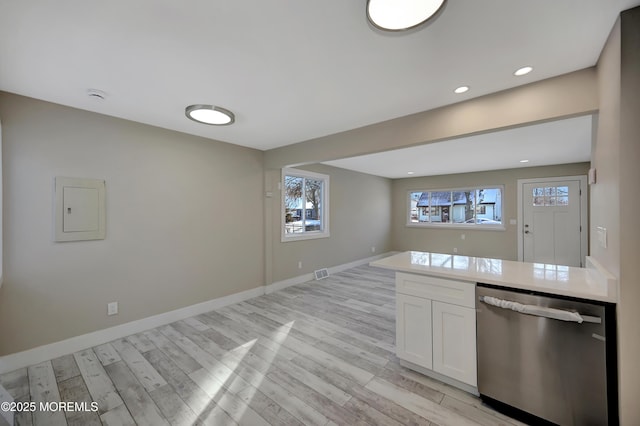 kitchen with dishwasher, light wood-type flooring, electric panel, and white cabinetry