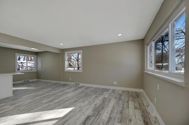 empty room with light hardwood / wood-style floors