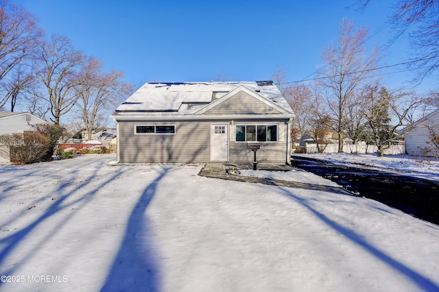 view of snow covered back of property