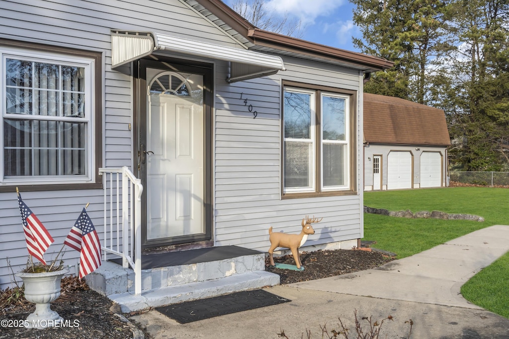 entrance to property with a lawn