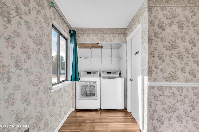 washroom with wood-type flooring, separate washer and dryer, and a wealth of natural light