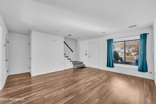 interior space with hardwood / wood-style floors and ornamental molding