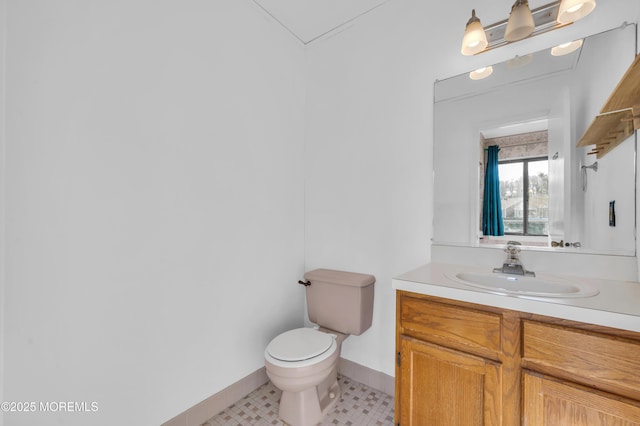 bathroom featuring tile patterned flooring, vanity, and toilet