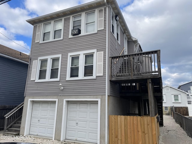 view of front of home featuring a balcony and a garage