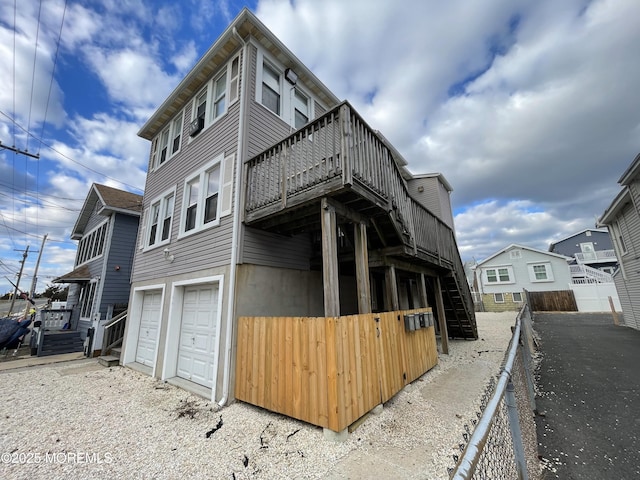 view of home's exterior with a deck and a garage