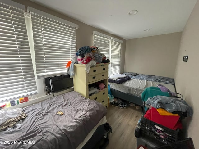 bedroom featuring light hardwood / wood-style flooring and cooling unit