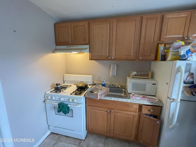 kitchen featuring white appliances, sink, and light tile patterned floors