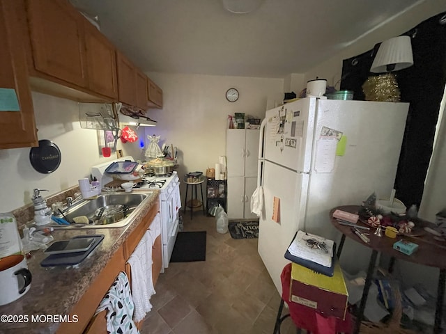 kitchen featuring white appliances and sink