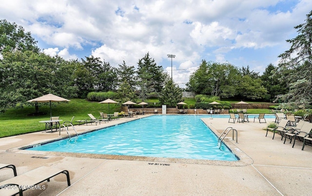 122 Orchid Ct Unit 1202, Toms River, NJ 08753 - community pool with a patio area, a lawn, and view of wooded area