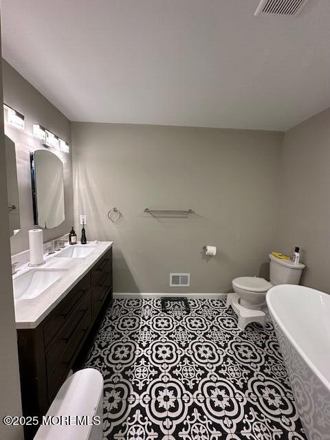 122 Orchid Ct Unit 1202, Toms River, NJ 08753 - full bath with a freestanding tub, toilet, baseboards, double vanity, and tile patterned flooring