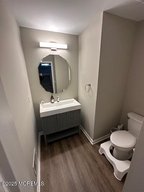 122 Orchid Ct Unit 1202, Toms River, NJ 08753 - bathroom with wood finished floors, toilet, vanity, and baseboards