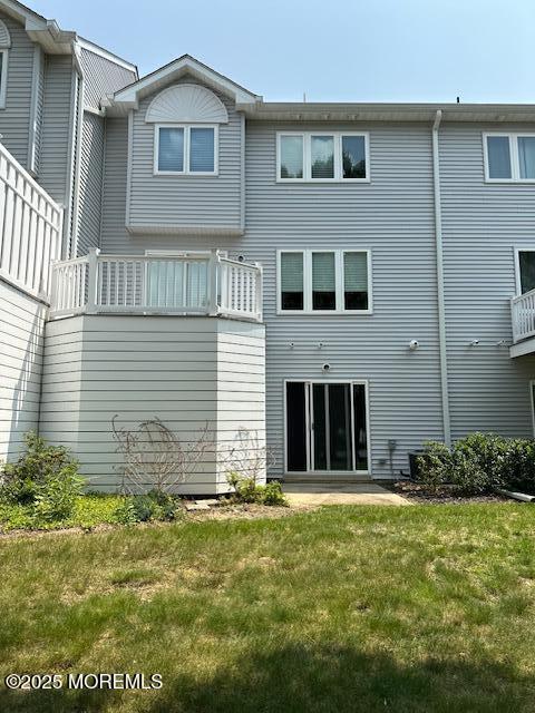 122 Orchid Ct Unit 1202, Toms River, NJ 08753 - rear view of house featuring a lawn