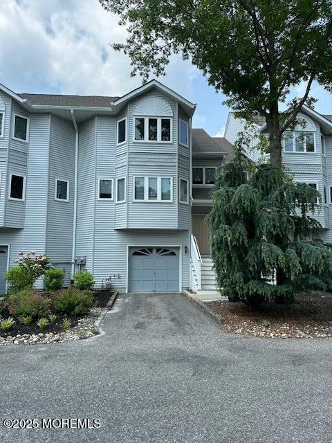 122 Orchid Ct Unit 1202, Toms River, NJ 08753 - view of front facade with a garage and driveway