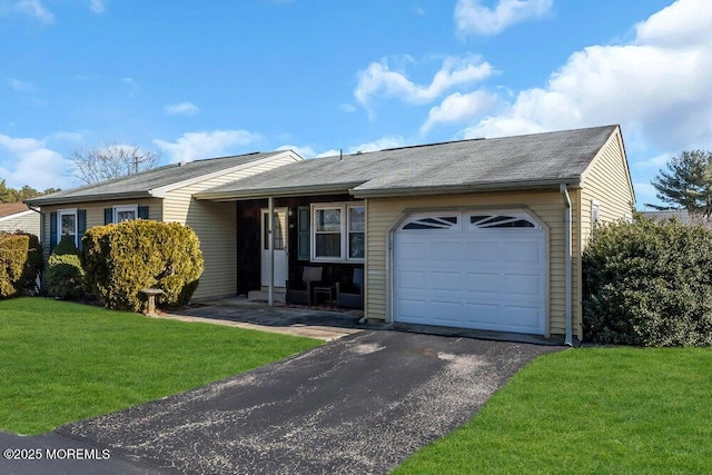 ranch-style home with a garage and a front yard