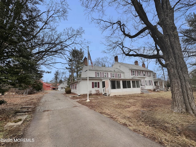 view of front of house featuring a sunroom