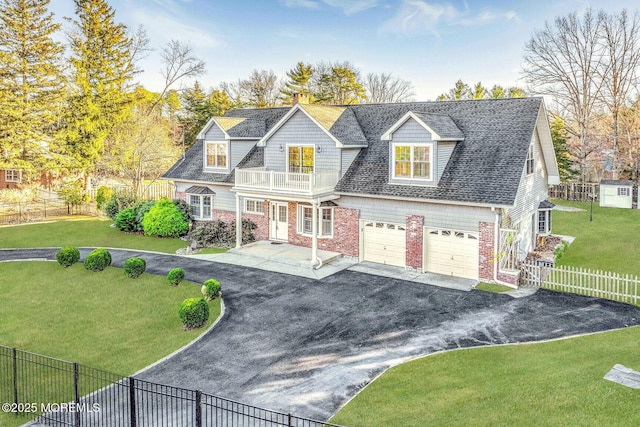 cape cod-style house with a front yard, a balcony, and a garage