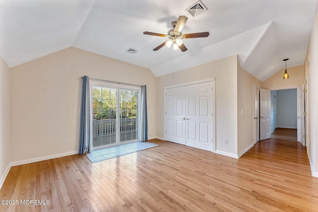 interior space featuring access to outside, vaulted ceiling, ceiling fan, light wood-type flooring, and a closet